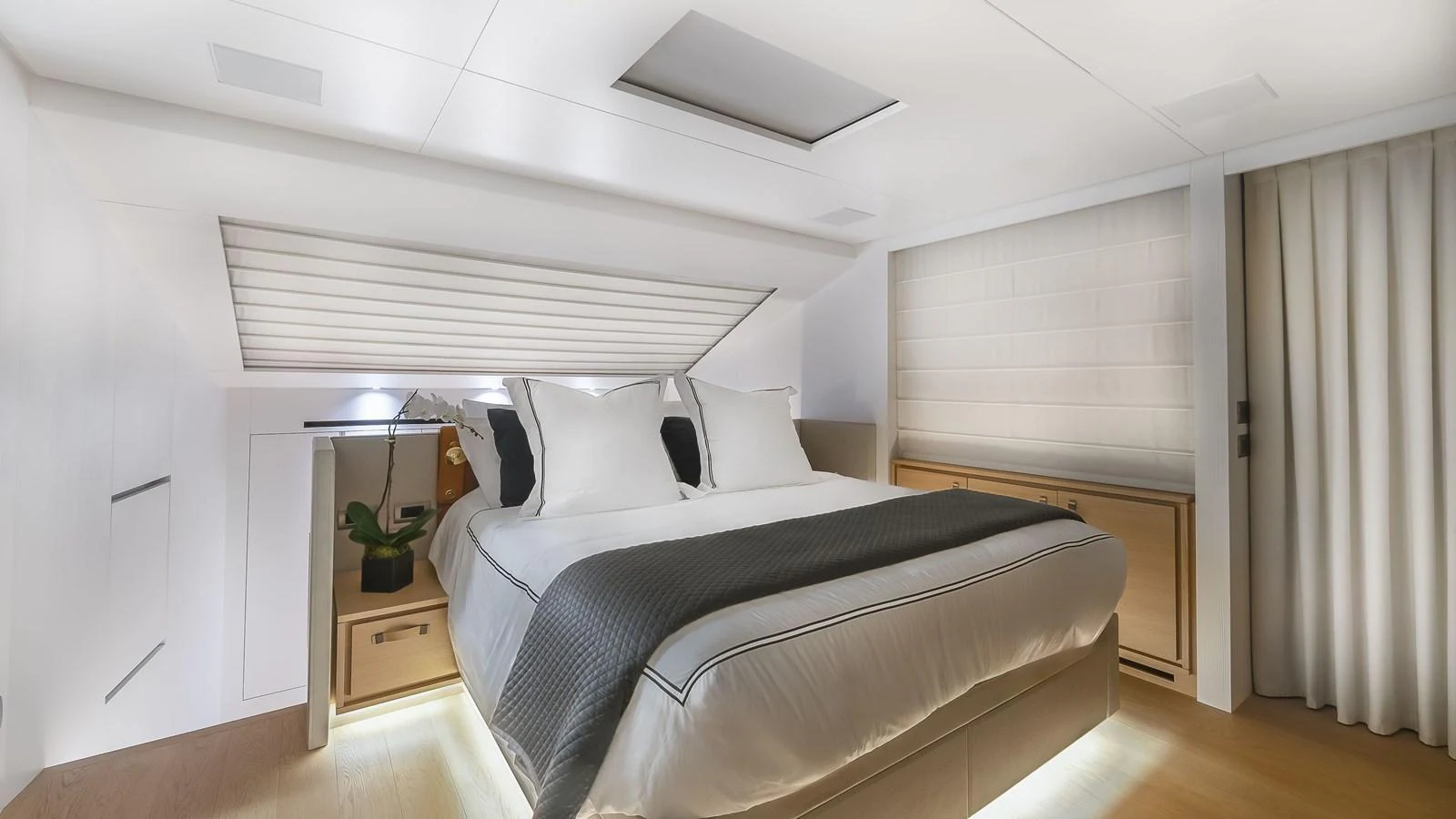 a bedroom with a bed and a desk aboard GATSBY Yacht for Sale