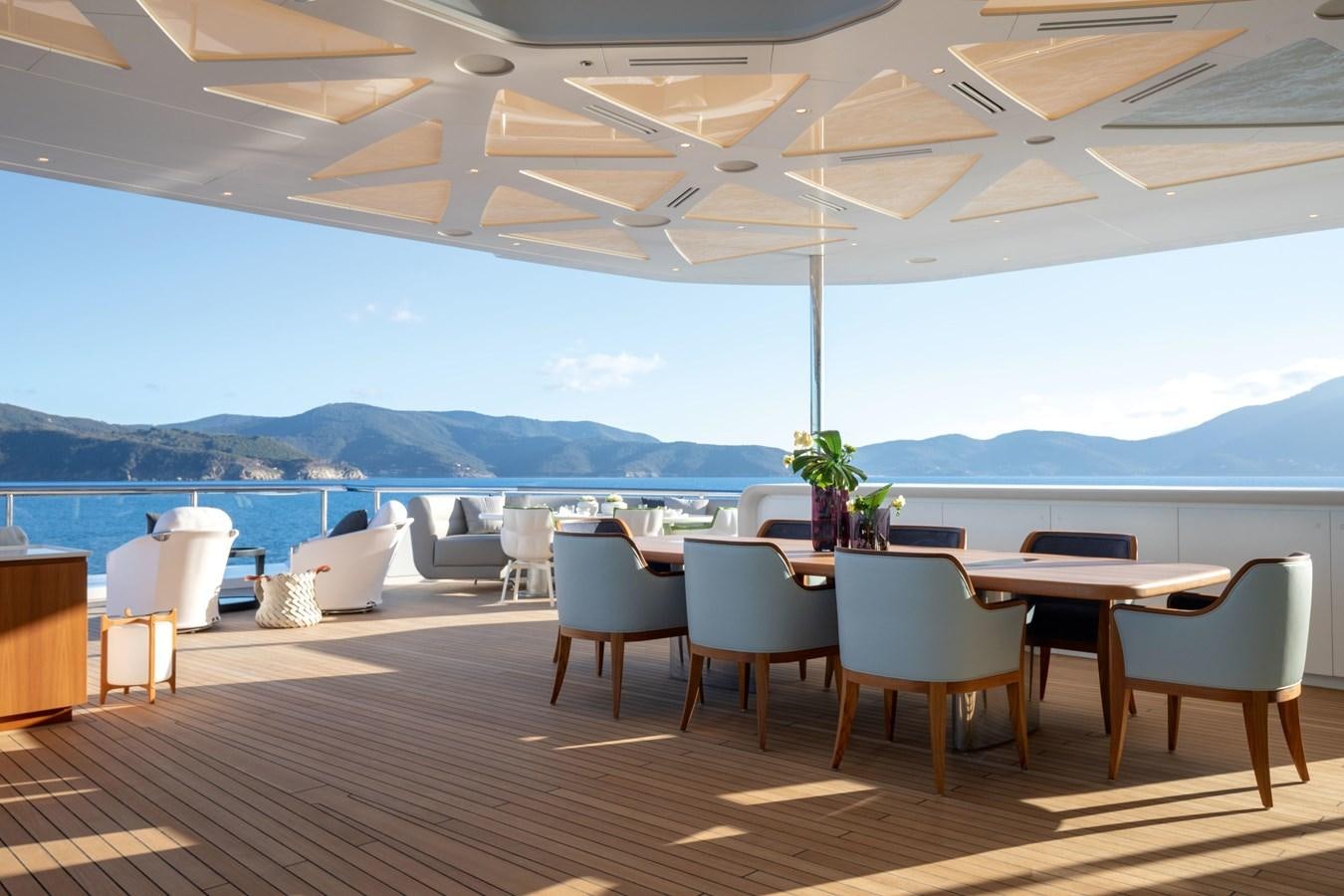 a room with tables and chairs aboard LUMINOSITY Yacht for Sale