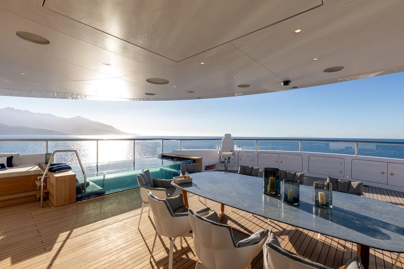 a room with a table and chairs aboard LUMINOSITY Yacht for Sale