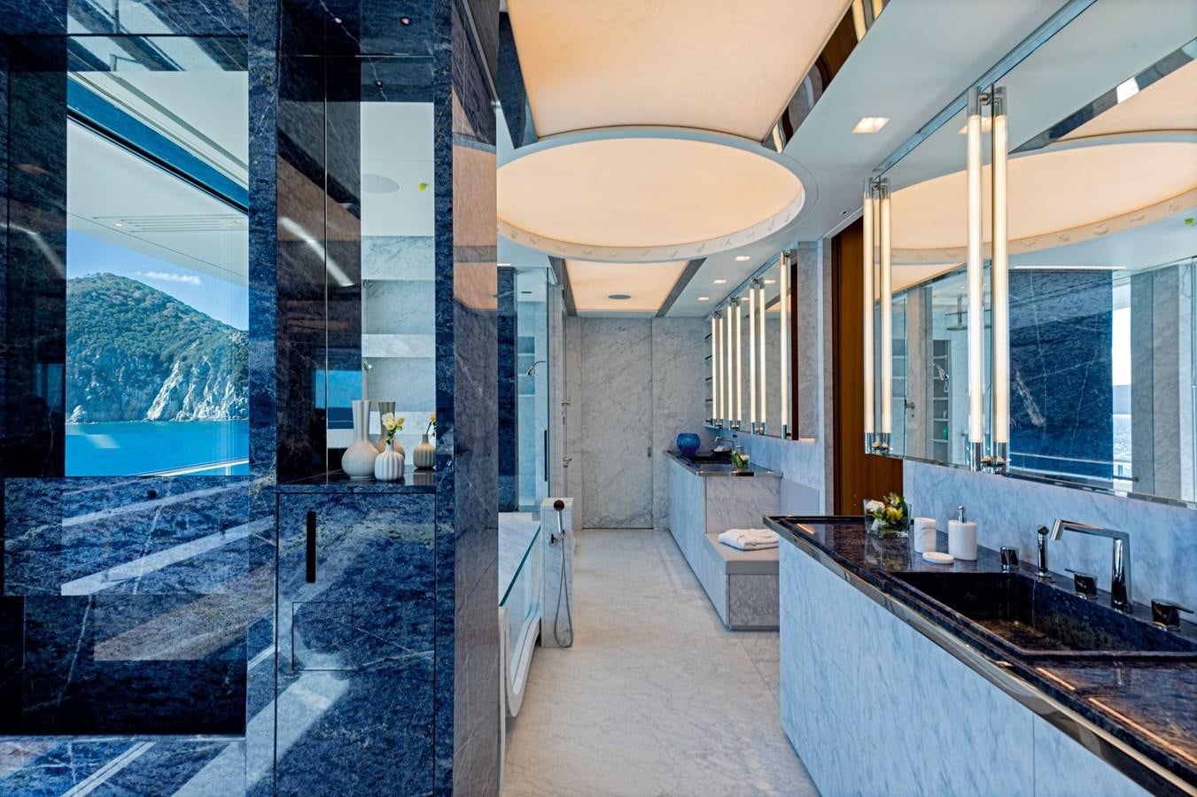 a bathroom with a large glass shower aboard LUMINOSITY Yacht for Sale