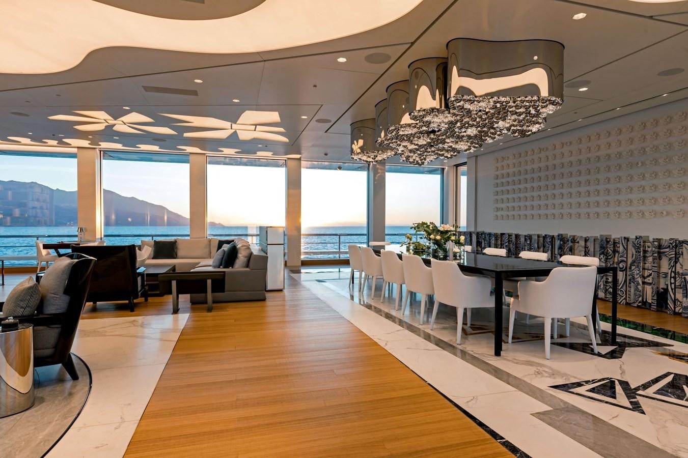 a room with tables and chairs aboard LUMINOSITY Yacht for Sale