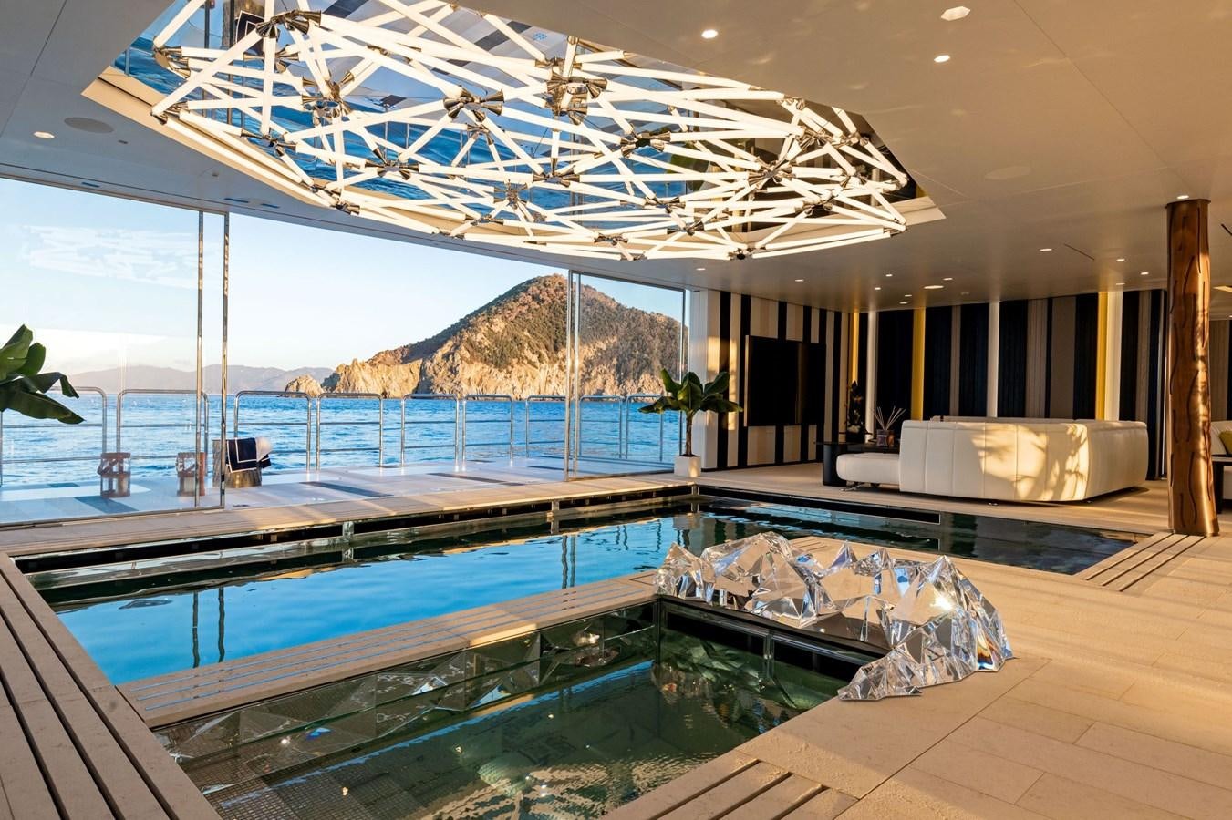 a large indoor swimming pool aboard LUMINOSITY Yacht for Sale