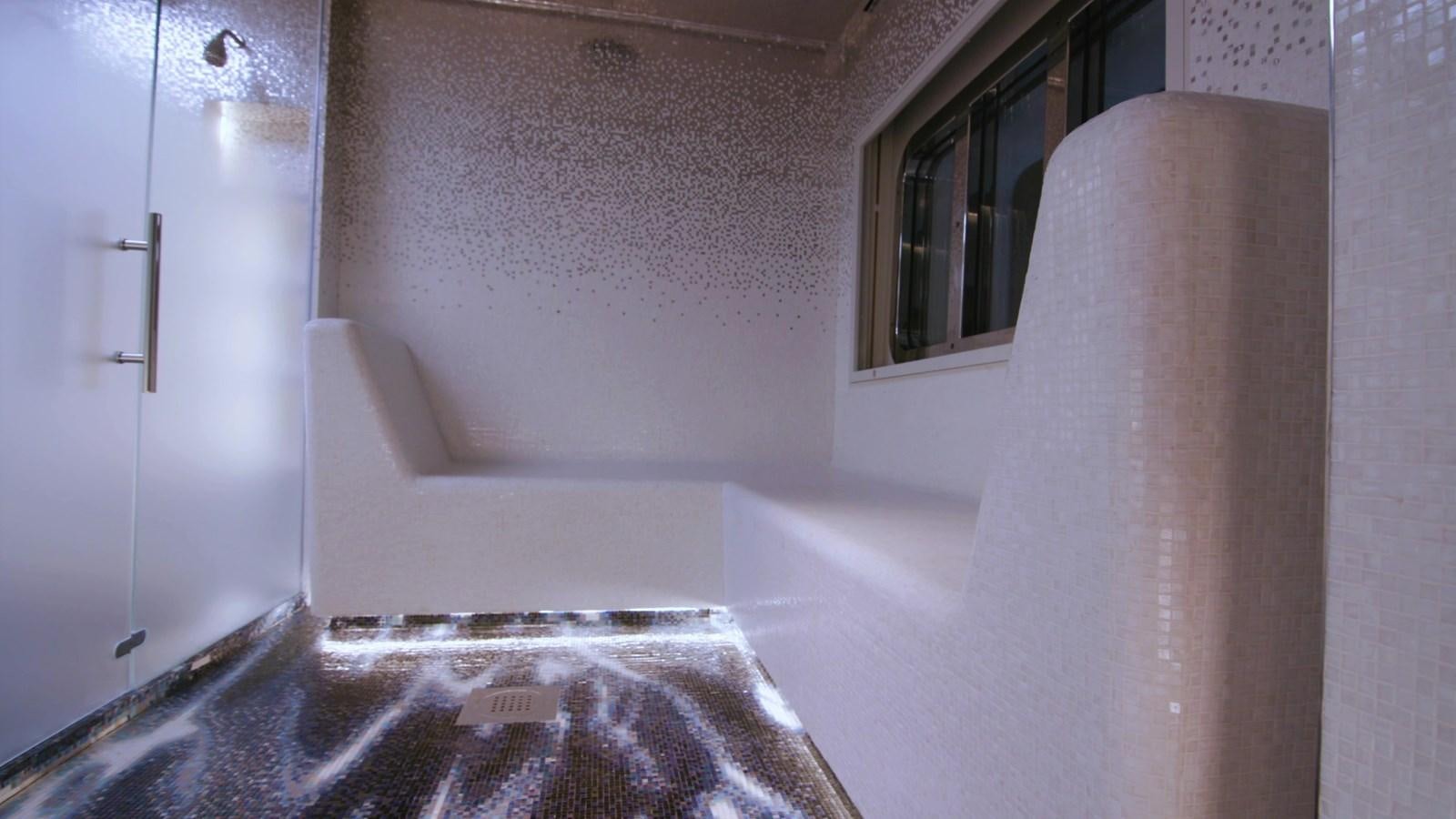 a room with a bed and a window aboard LUMINOSITY Yacht for Sale