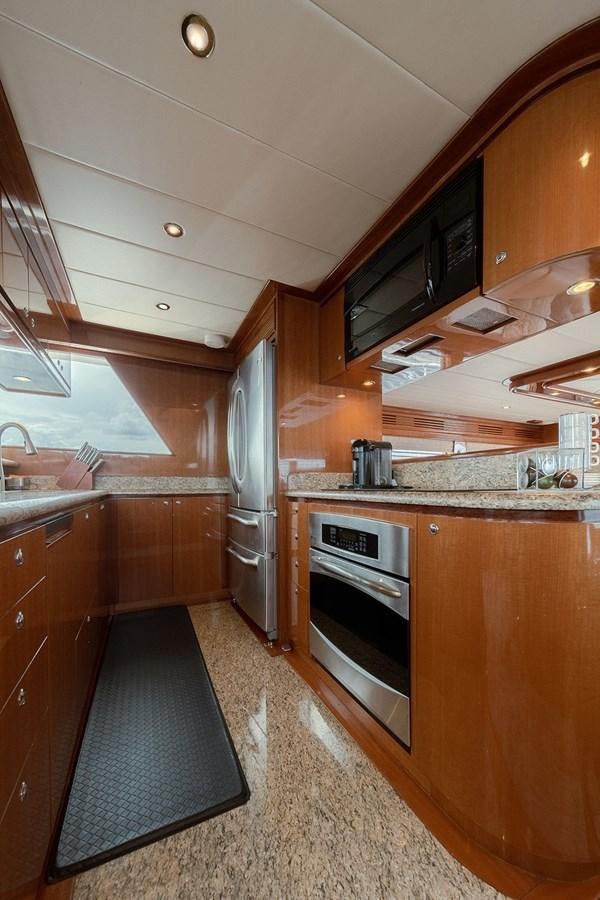 a kitchen with wooden cabinets aboard ISOBEL III Yacht for Sale