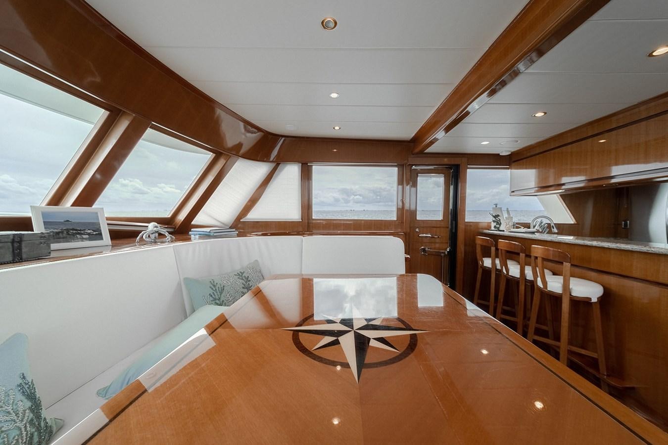 a room with a table and chairs aboard ISOBEL III Yacht for Sale