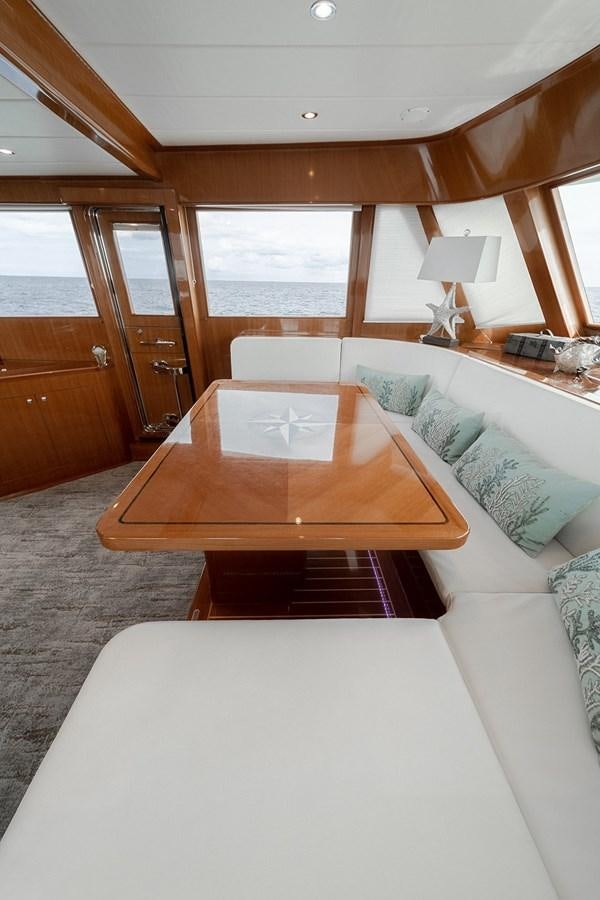 a large living room with a large table and a couch aboard ISOBEL III Yacht for Sale