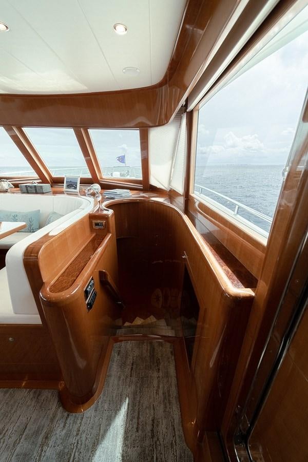 a wooden boat with a seat aboard ISOBEL III Yacht for Sale