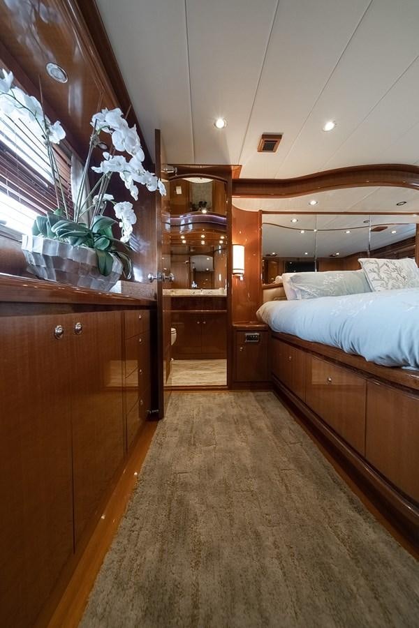 a bedroom with a bed and a desk aboard ISOBEL III Yacht for Sale