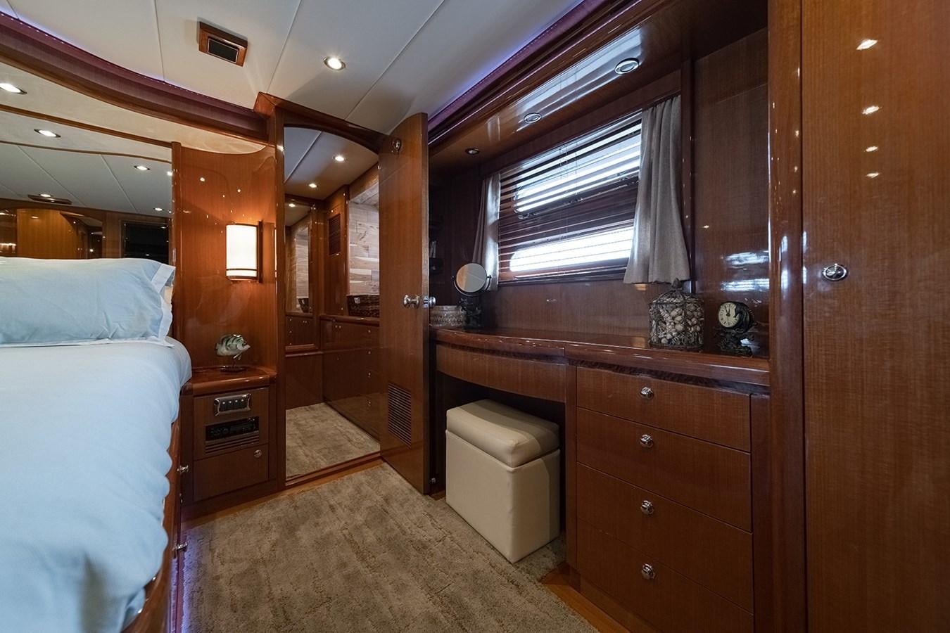 a bedroom with a bed and a closet aboard ISOBEL III Yacht for Sale
