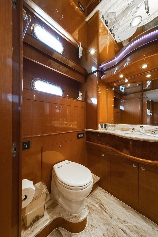 a bathroom with a toilet and a sink aboard ISOBEL III Yacht for Sale