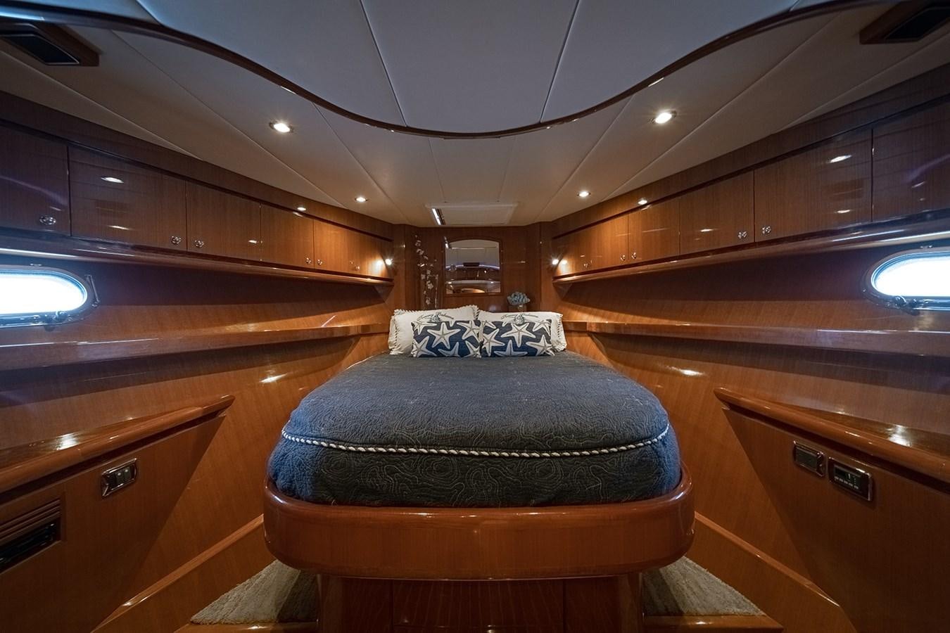 a room with a bed and a dresser aboard ISOBEL III Yacht for Sale
