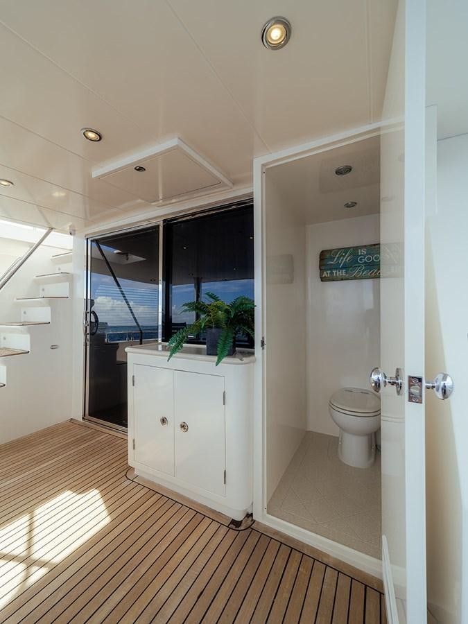 a bathroom with a wood floor aboard ISOBEL III Yacht for Sale