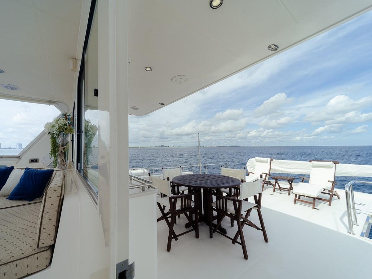 a room with a table and chairs aboard ISOBEL III Yacht for Sale