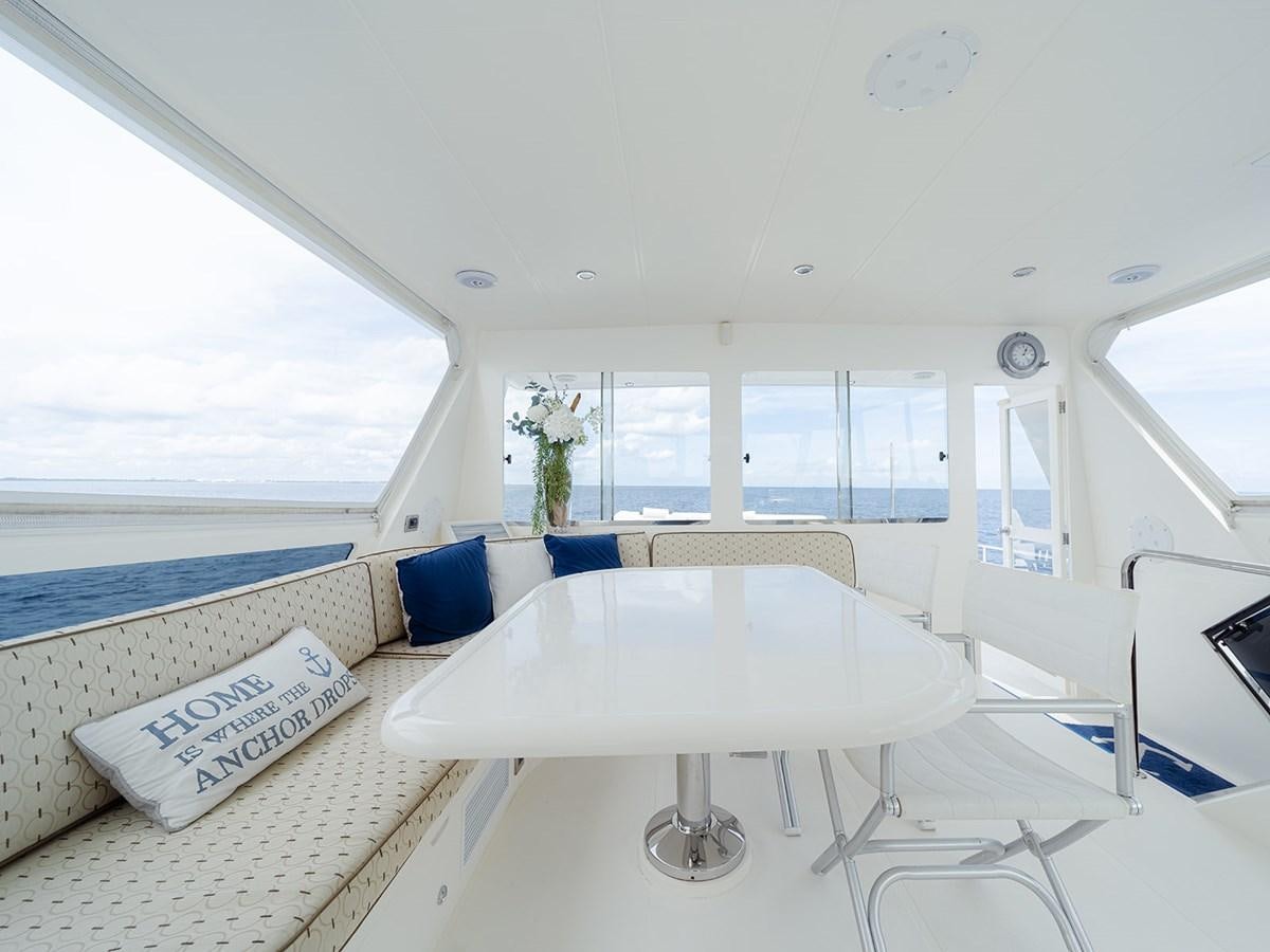 a white table with chairs around it aboard ISOBEL III Yacht for Sale