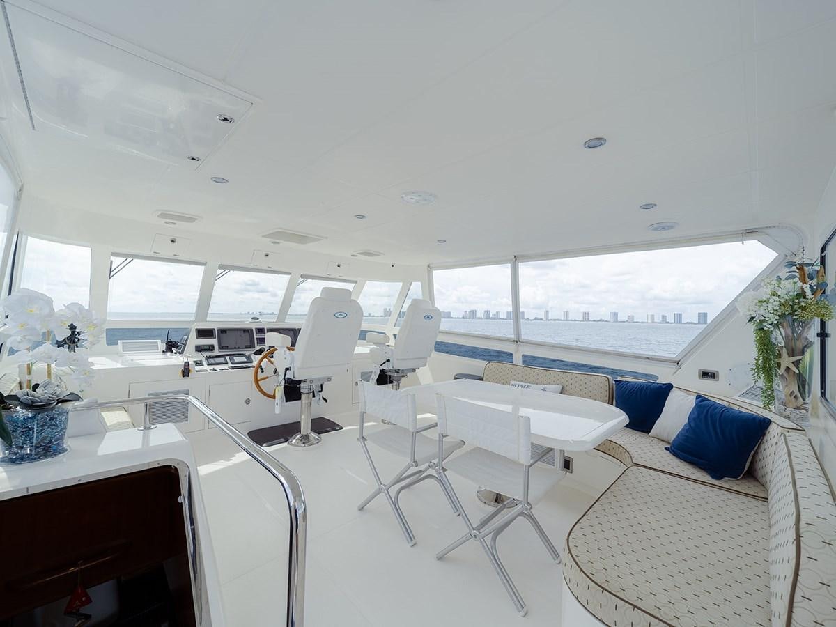 a room with white chairs and tables aboard ISOBEL III Yacht for Sale