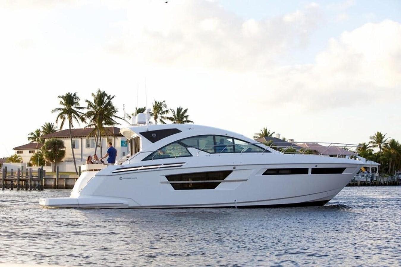 a white yacht on the water aboard 54 FT 2023 CRUISERS  54 CANTIUS Yacht for Sale