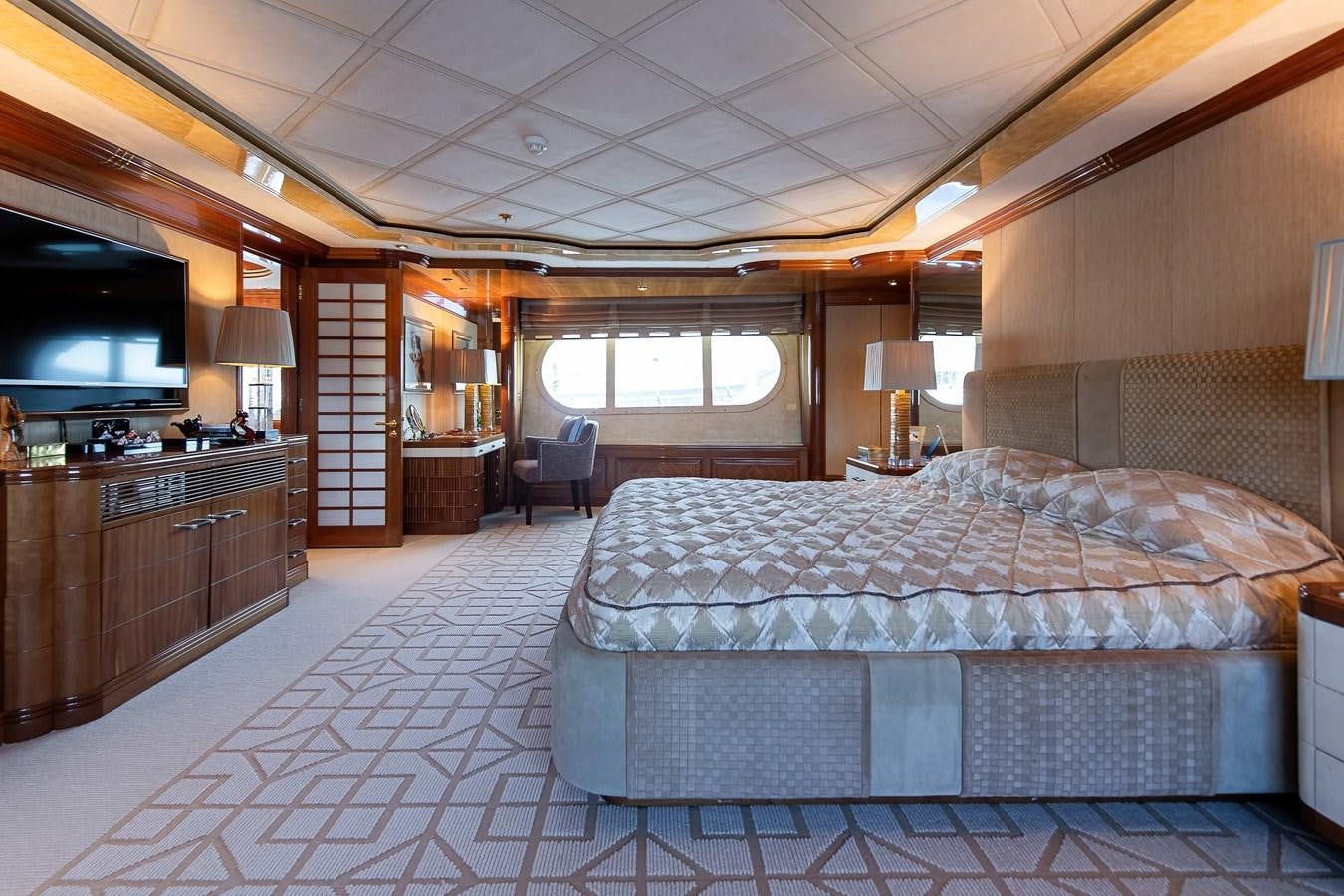 a bedroom with a bed and a tv aboard PETARA Yacht for Sale