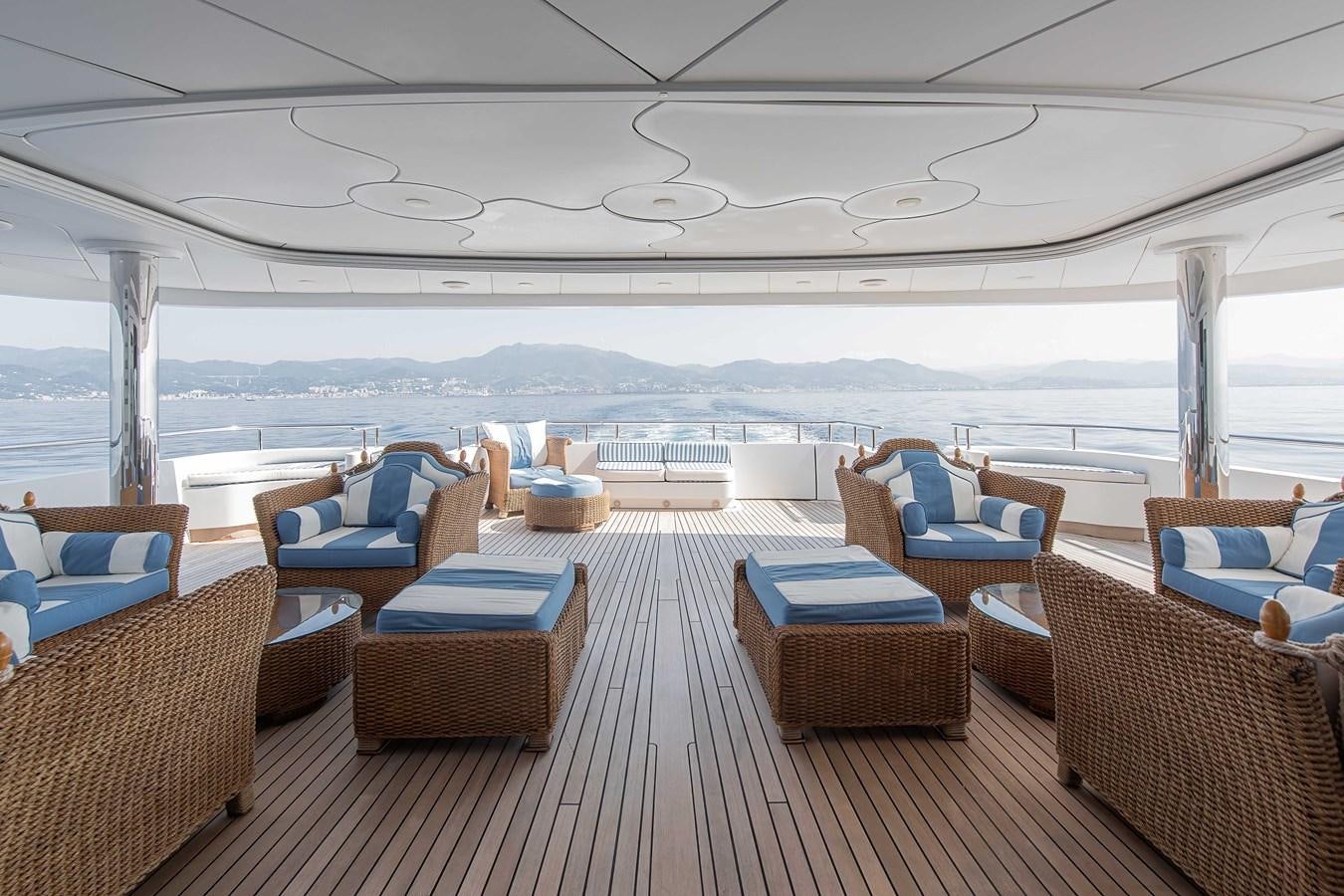 a large patio with chairs and tables aboard PETARA Yacht for Sale
