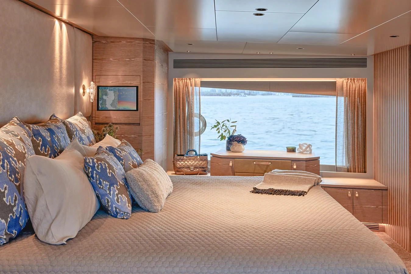 a bed with pillows and a table aboard ASKARI Yacht for Sale