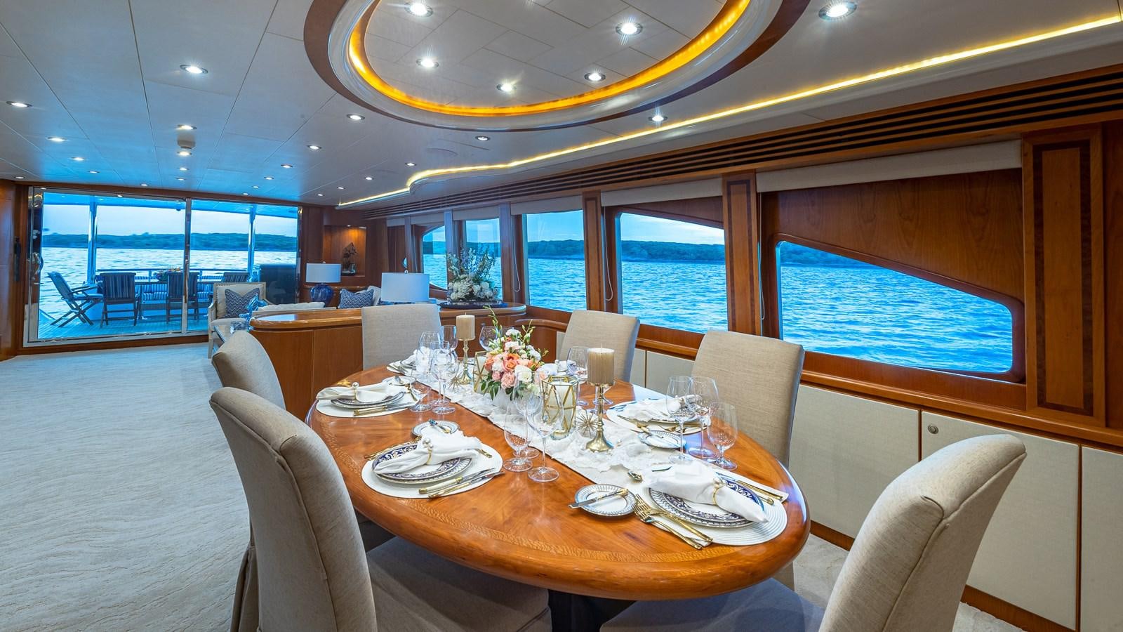 a dining room with a large window aboard B HAPPY Yacht for Sale