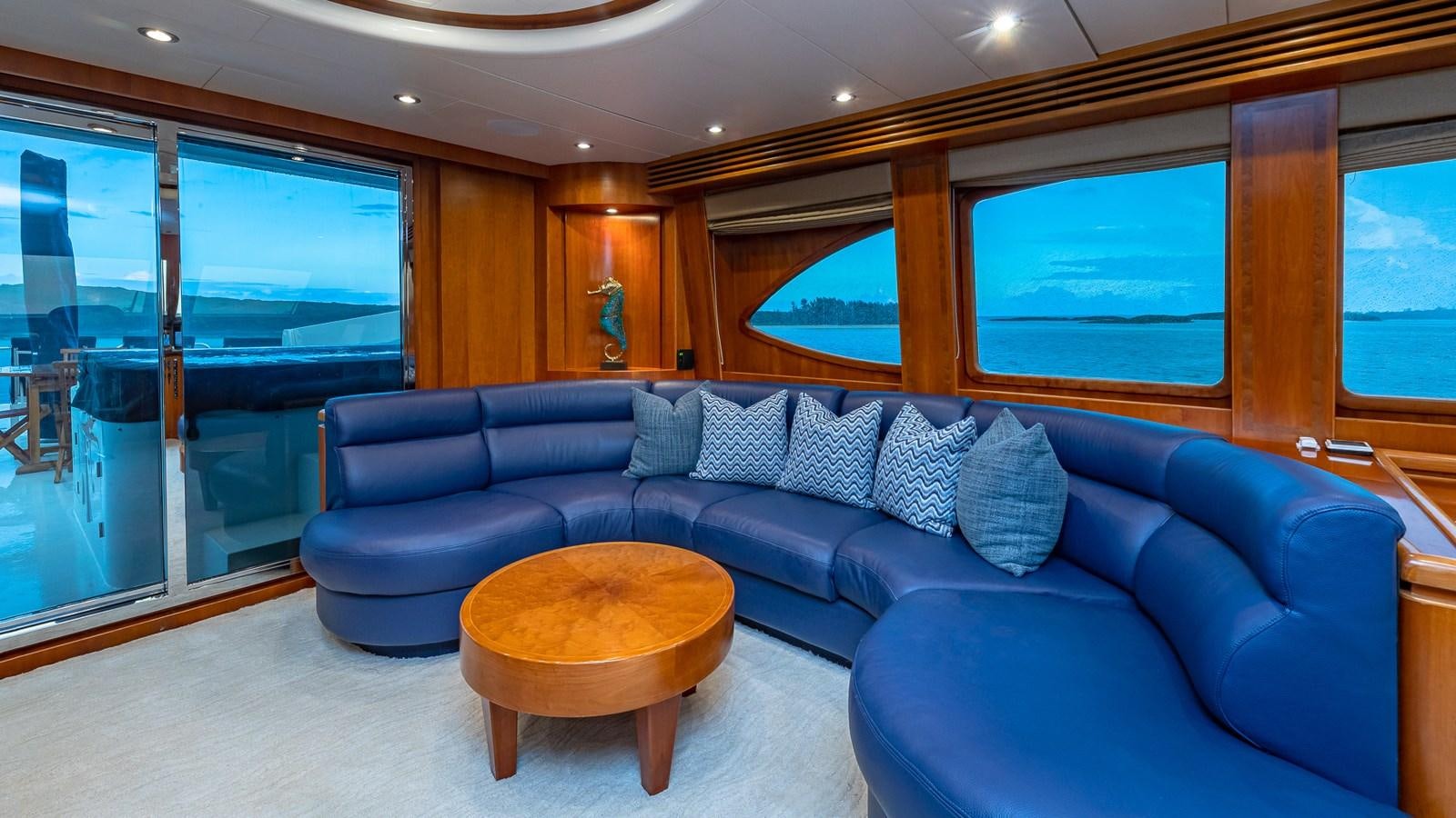 a living room with a blue couch aboard B HAPPY Yacht for Sale