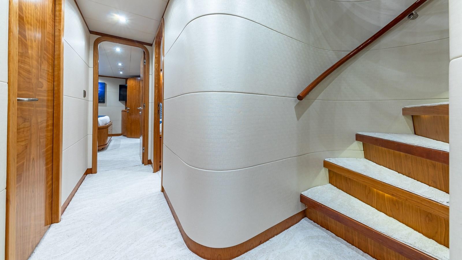 a room with a staircase and a white wall aboard B HAPPY Yacht for Sale