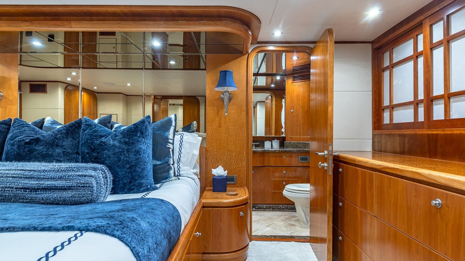 a bedroom with a bed and a mirror aboard B HAPPY Yacht for Sale