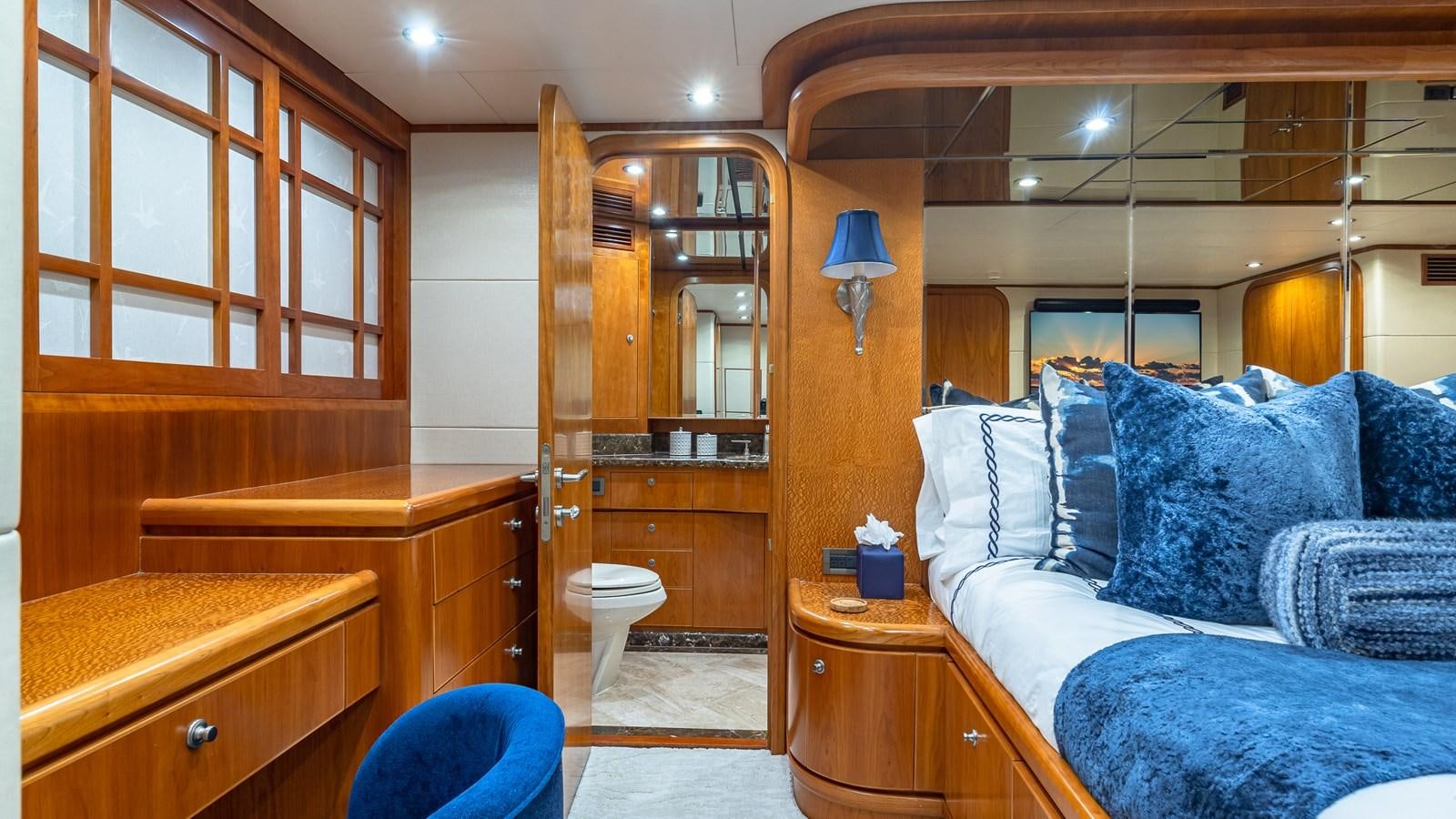 a bedroom with a bed and a desk aboard B HAPPY Yacht for Sale