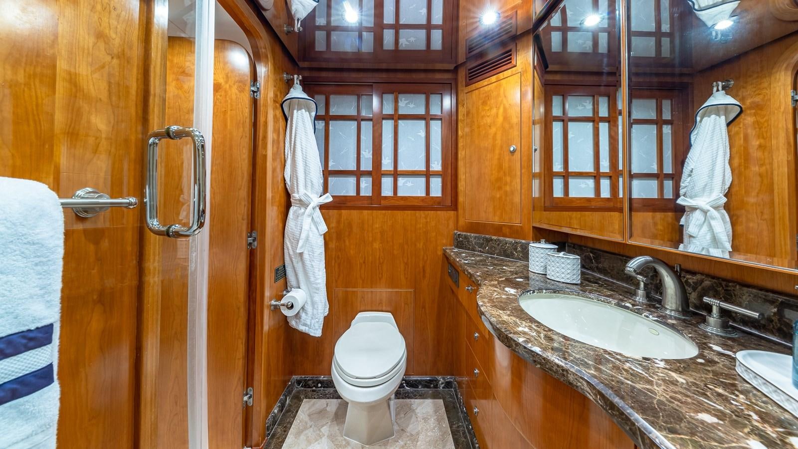 a bathroom with a sink toilet and a mirror aboard B HAPPY Yacht for Sale
