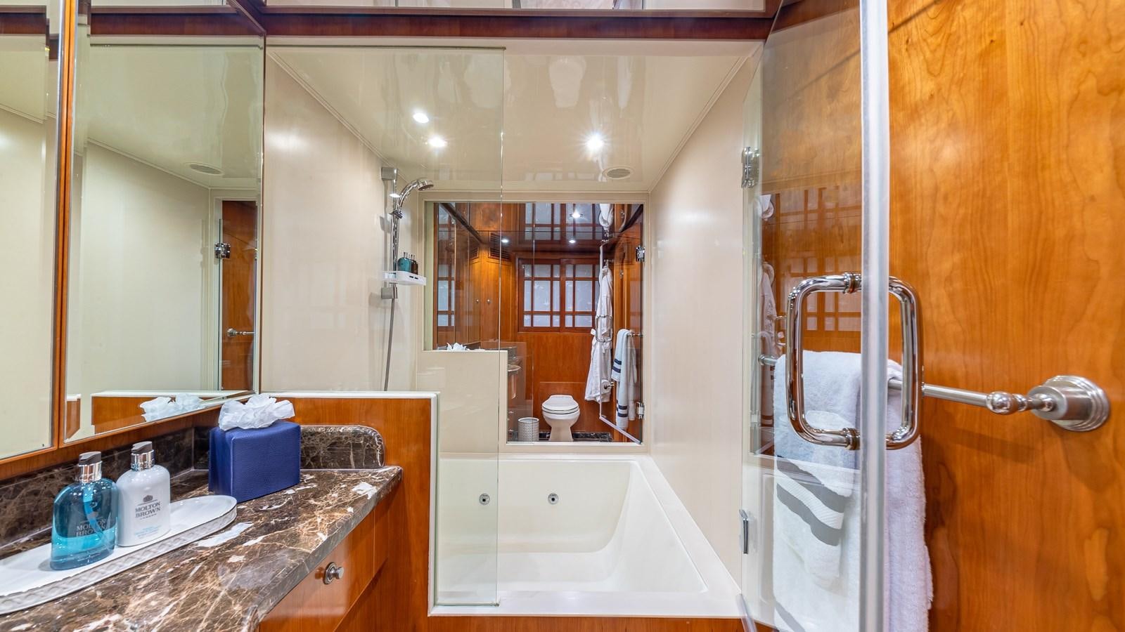 a bathroom with a tub sink and a mirror aboard B HAPPY Yacht for Sale