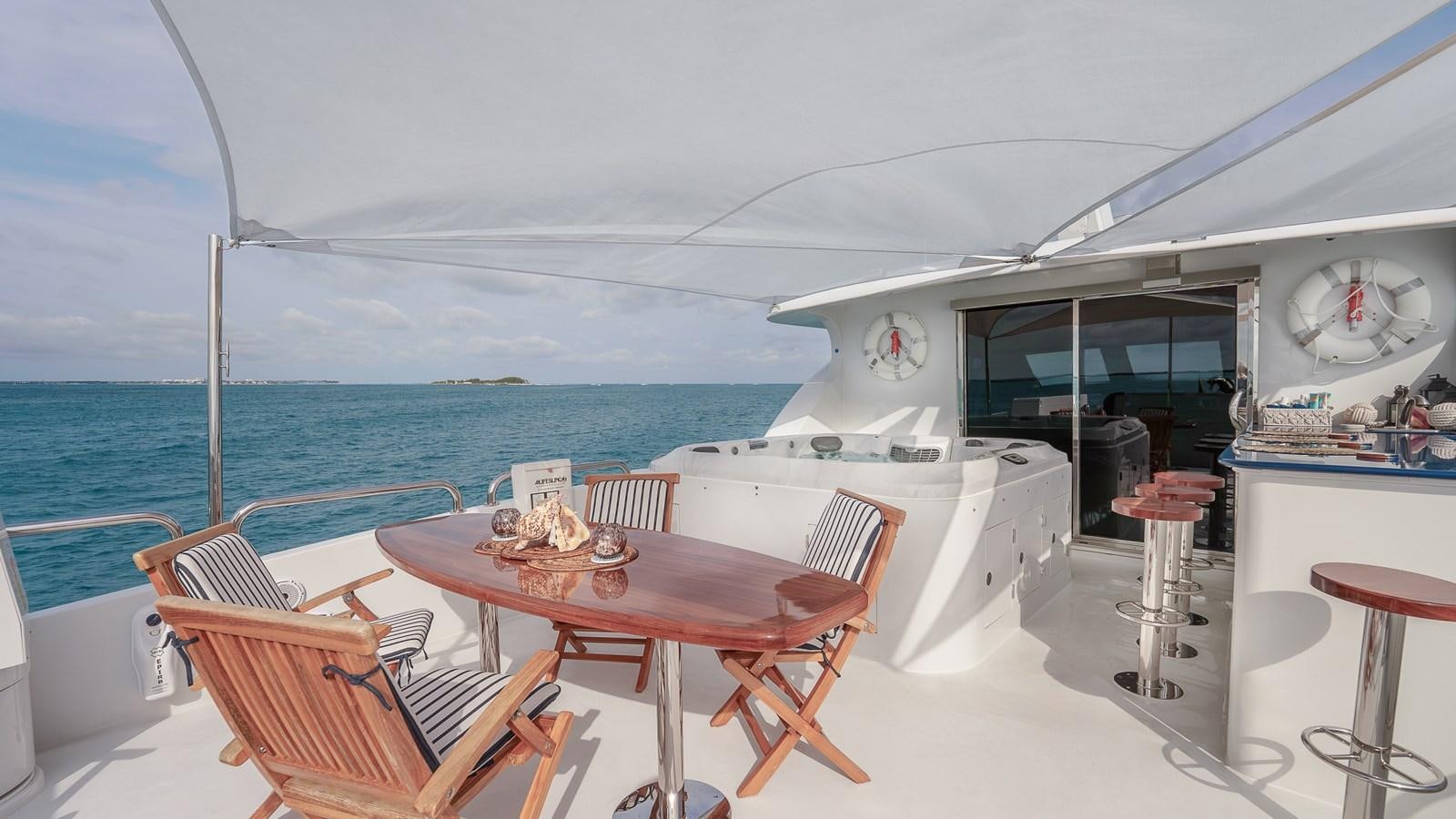 a table and chairs on a boat aboard B HAPPY Yacht for Sale