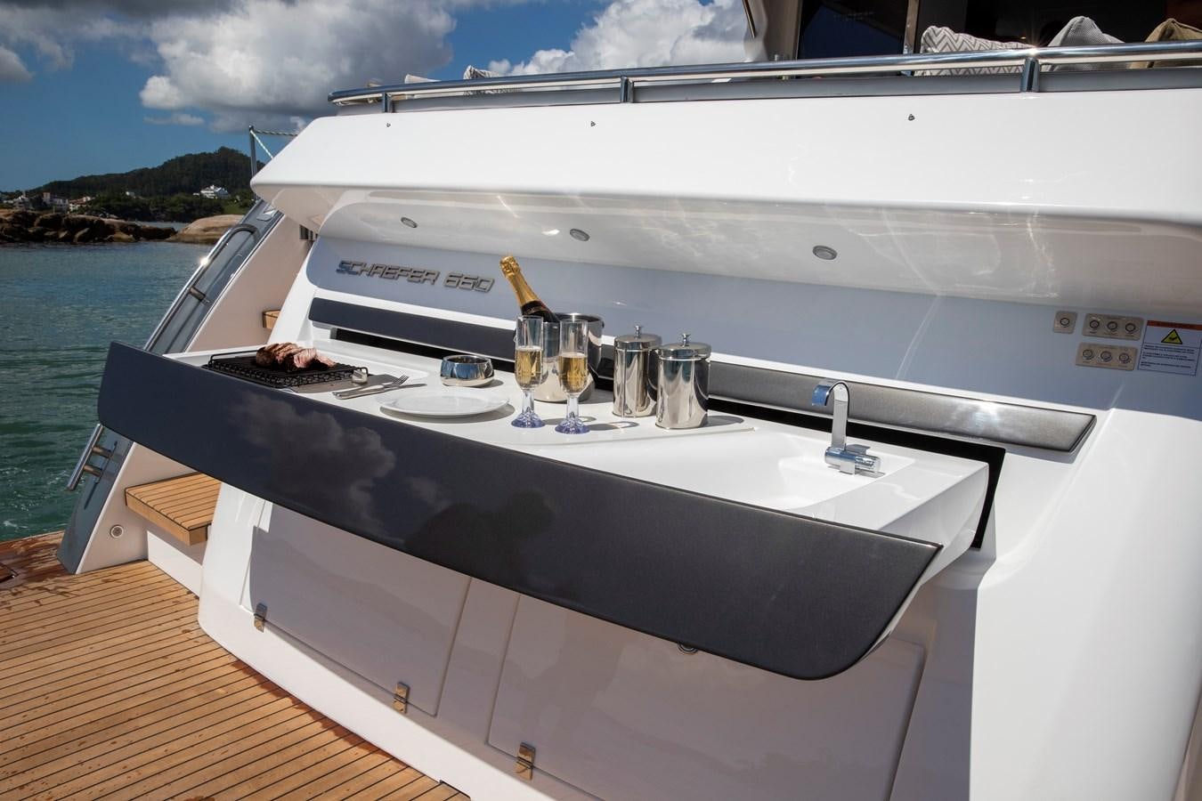 a boat with a glass of wine on the deck aboard SCHAEFER 660 Yacht for Sale