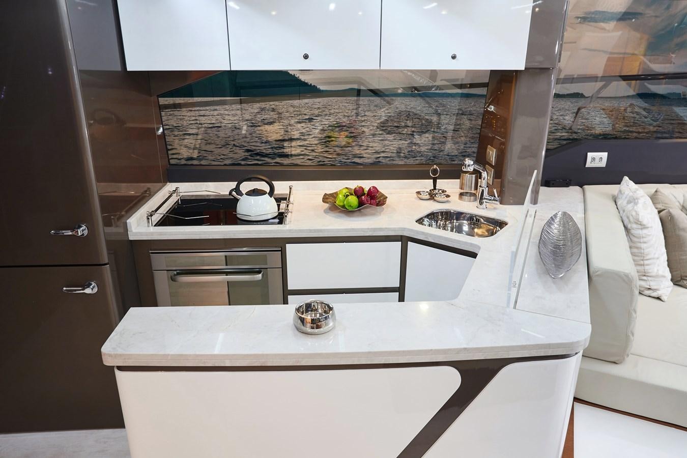 a kitchen with white cabinets aboard SCHAEFER 660 Yacht for Sale
