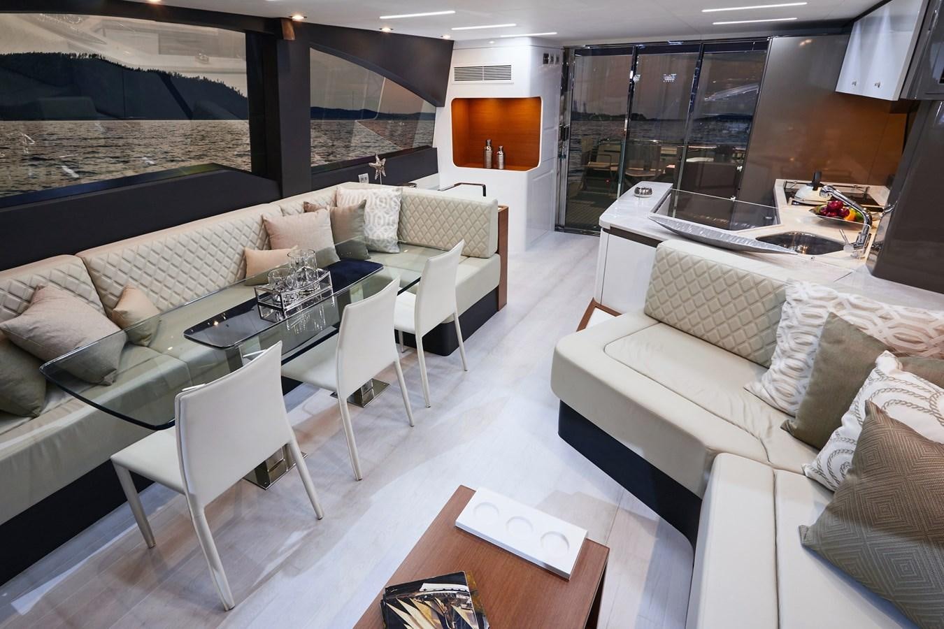 a room with a couch and a table and chairs aboard SCHAEFER 660 Yacht for Sale