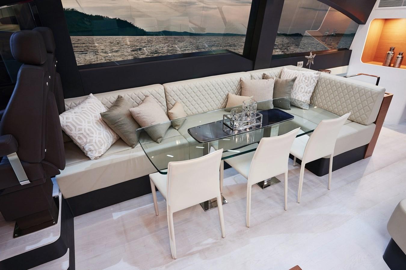 a room with a table chairs and a couch aboard SCHAEFER 660 Yacht for Sale