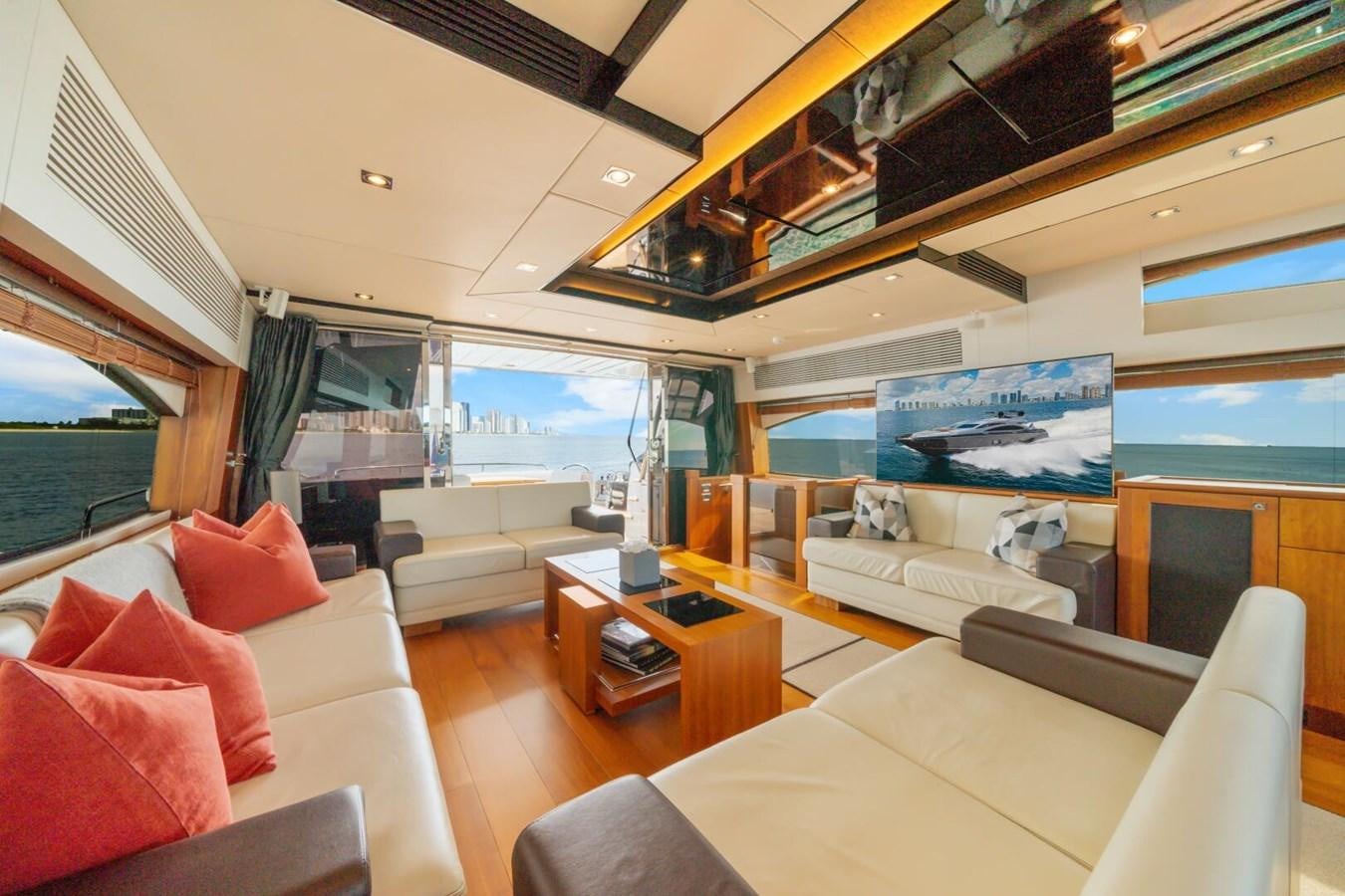a living room with a large window aboard PREDATOR 84 Yacht for Sale