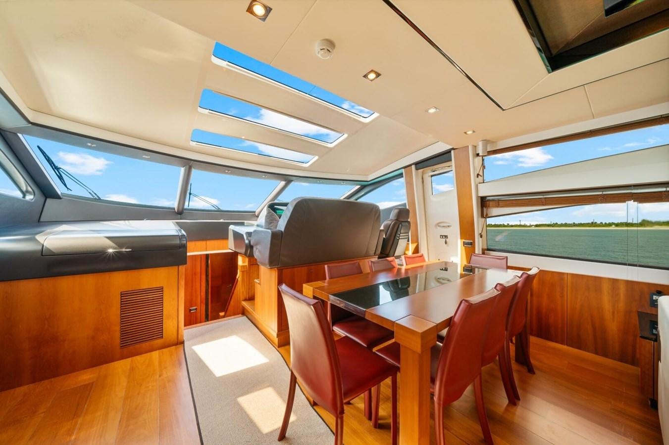a room with a table and chairs aboard PREDATOR 84 Yacht for Sale