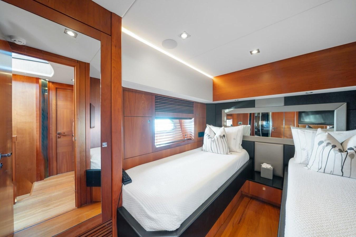 a room with a bed and a closet aboard PREDATOR 84 Yacht for Sale