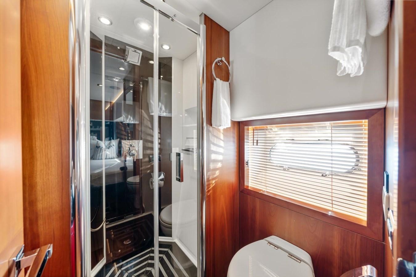 a bathroom with a glass shower aboard PREDATOR 84 Yacht for Sale