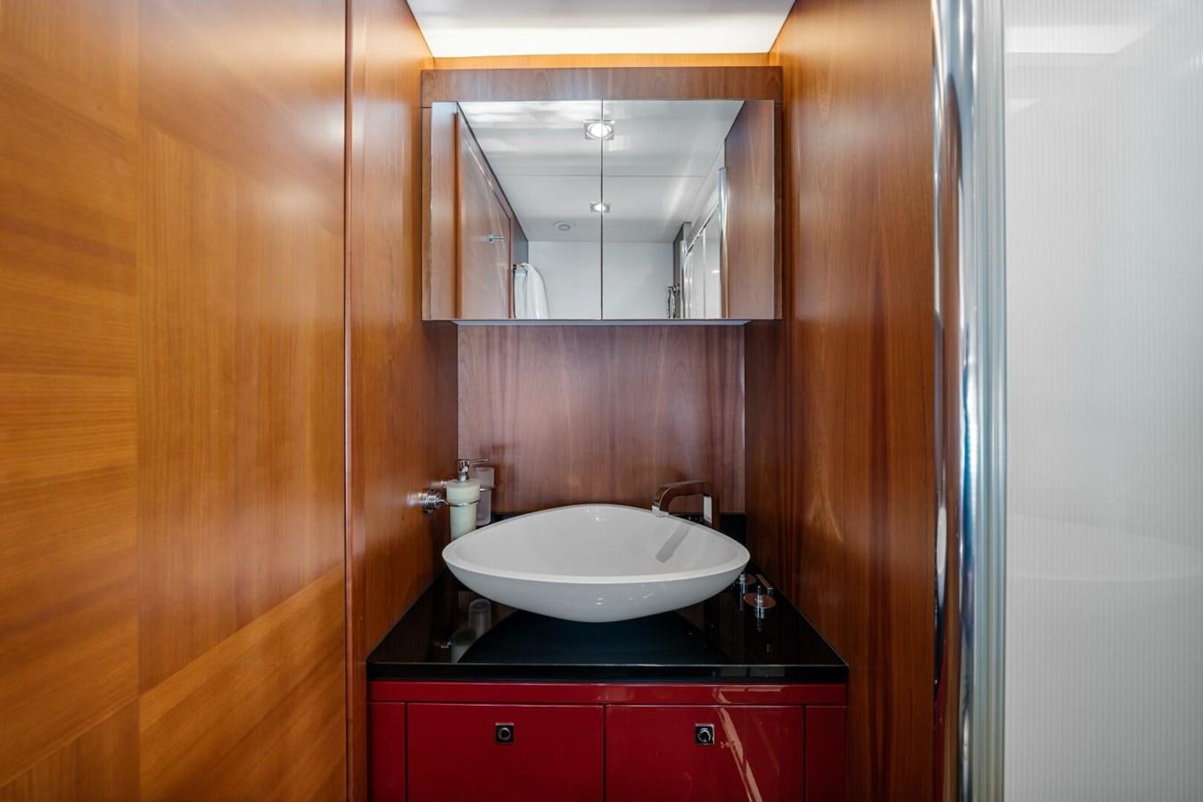 a bathroom with a sink and mirror aboard PREDATOR 84 Yacht for Sale