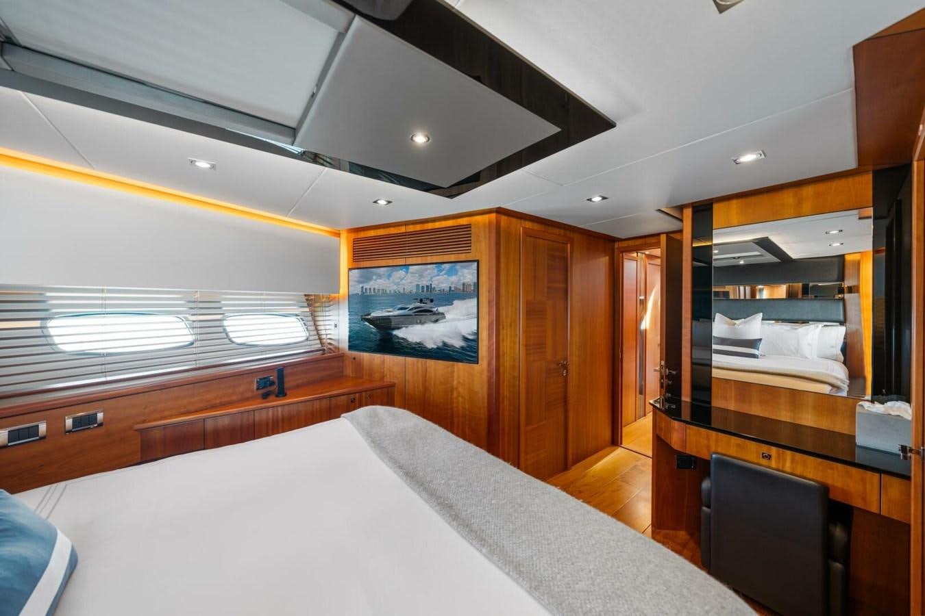 a room with a bed and a desk aboard PREDATOR 84 Yacht for Sale