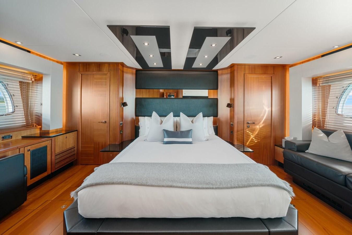 a bedroom with a bed and a desk aboard PREDATOR 84 Yacht for Sale
