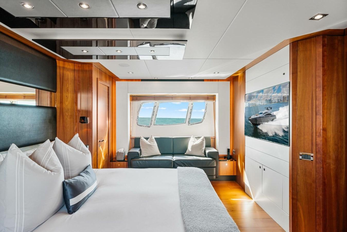 a room with a bed and a couch aboard PREDATOR 84 Yacht for Sale