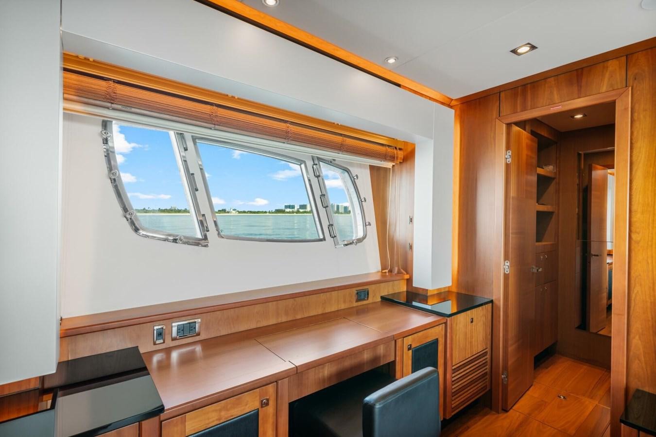 a room with a window and a desk aboard PREDATOR 84 Yacht for Sale