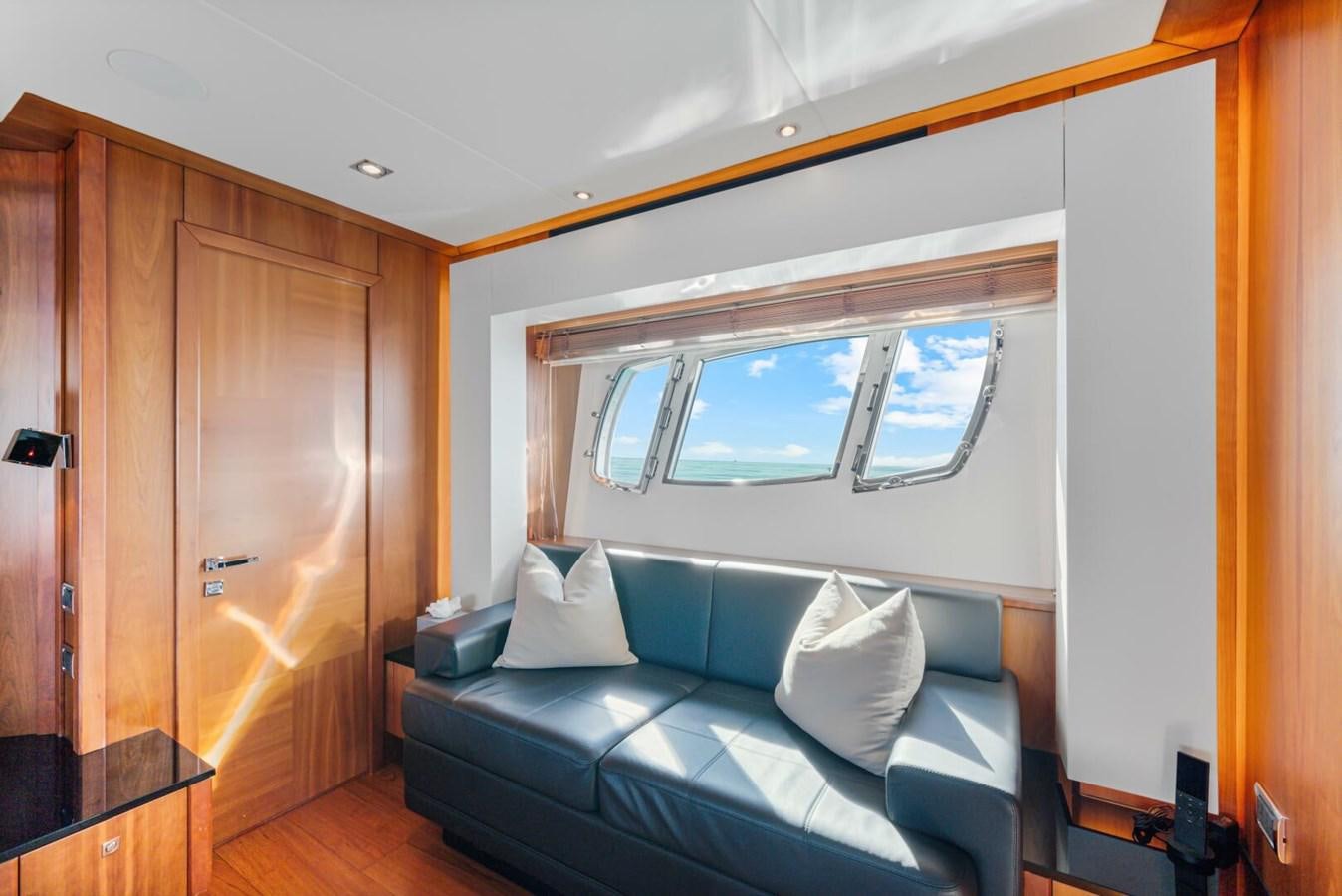 a couch in a room aboard PREDATOR 84 Yacht for Sale