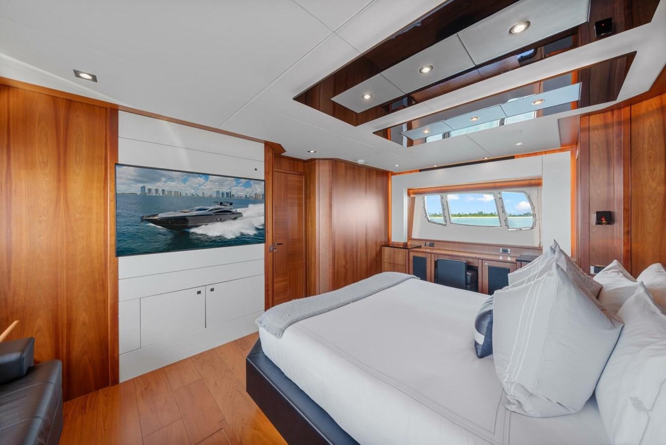 a bedroom with a large bed aboard PREDATOR 84 Yacht for Sale