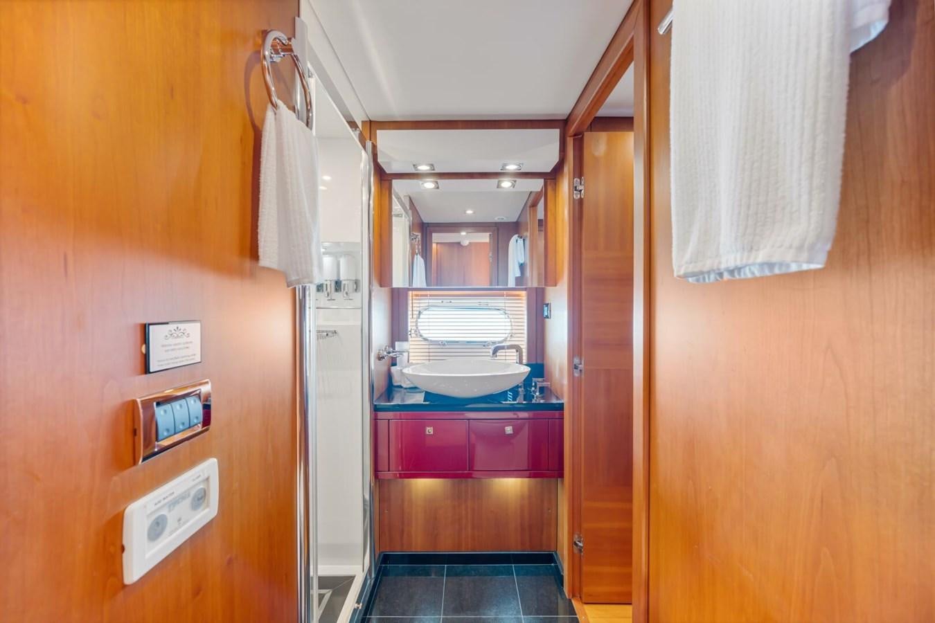 a bathroom with a sink and a mirror aboard PREDATOR 84 Yacht for Sale