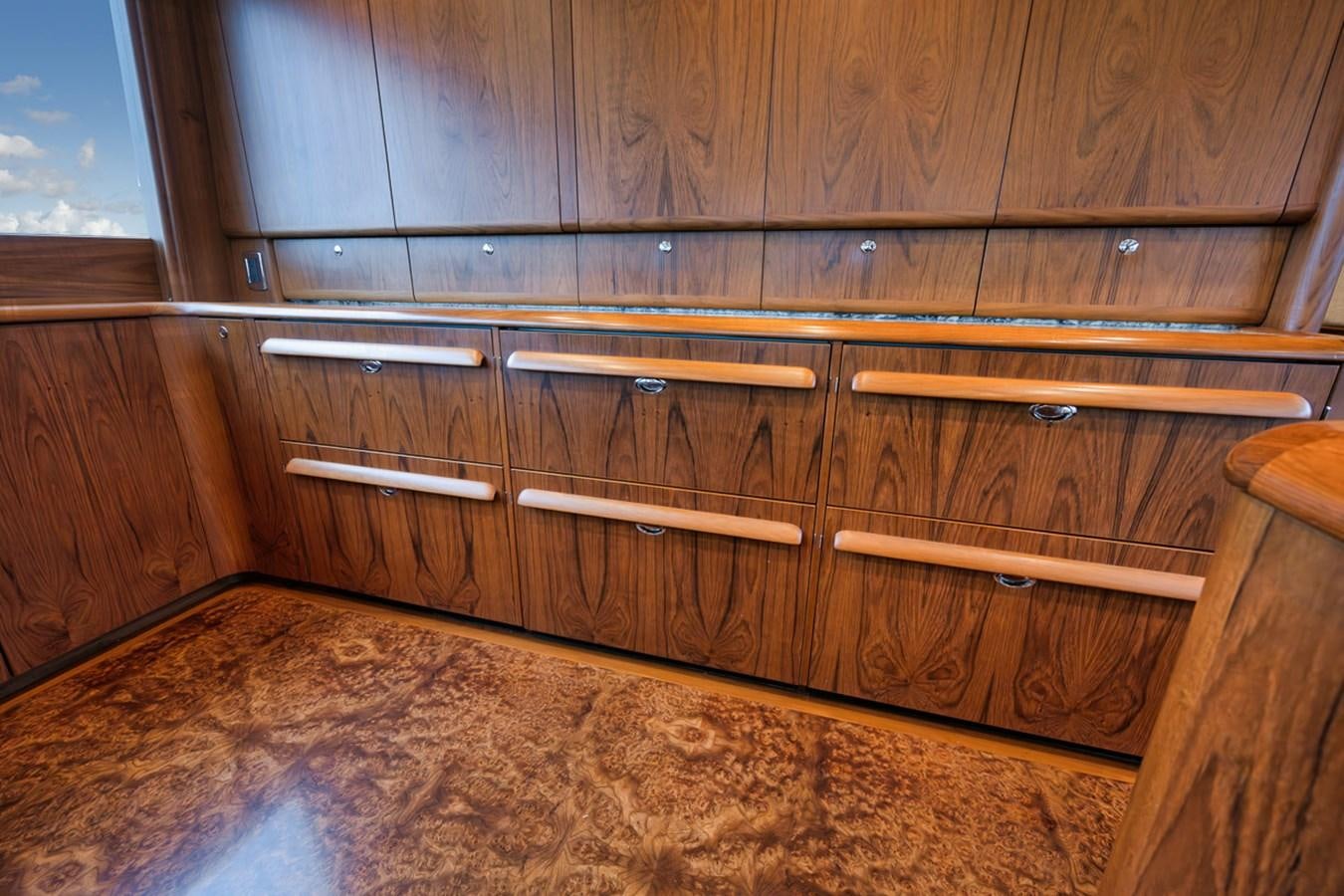 a wooden dresser with a rug aboard ARTEMIS Yacht for Sale
