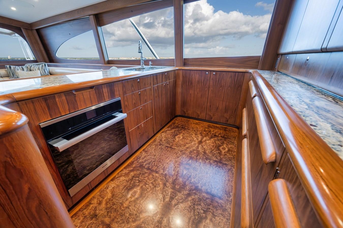 a kitchen with wooden cabinets aboard ARTEMIS Yacht for Sale