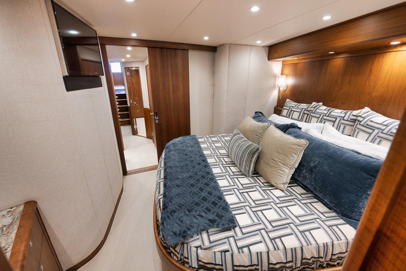 a bedroom with a bed and a wood door aboard ARTEMIS Yacht for Sale